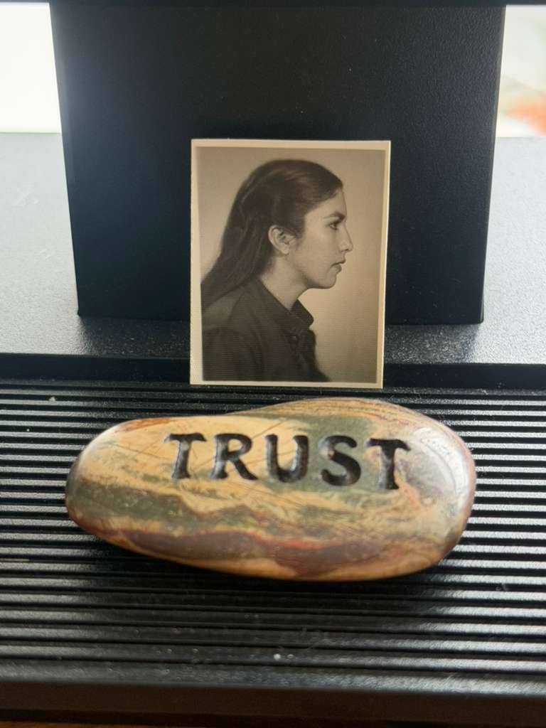 a photo of margoth and a stone that says trust